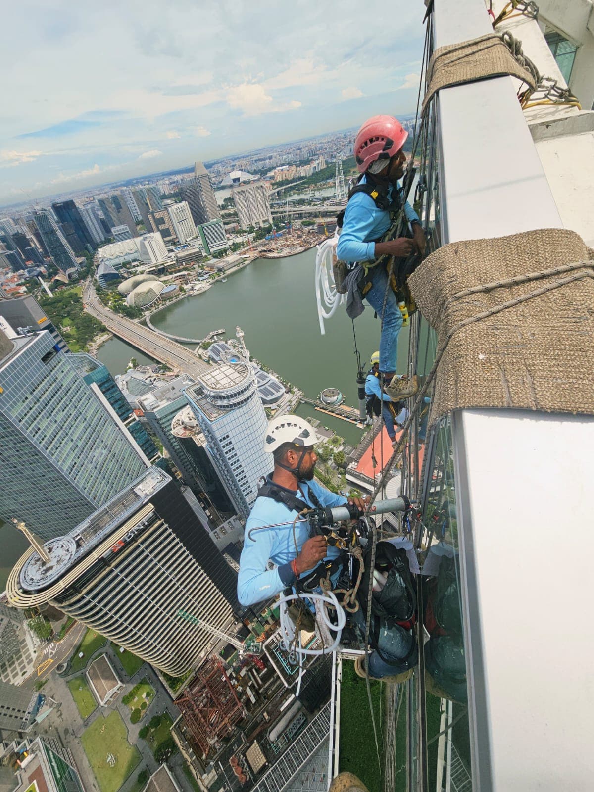 Hydroseal rope-access technicians working high above Marina Bay, Singapore